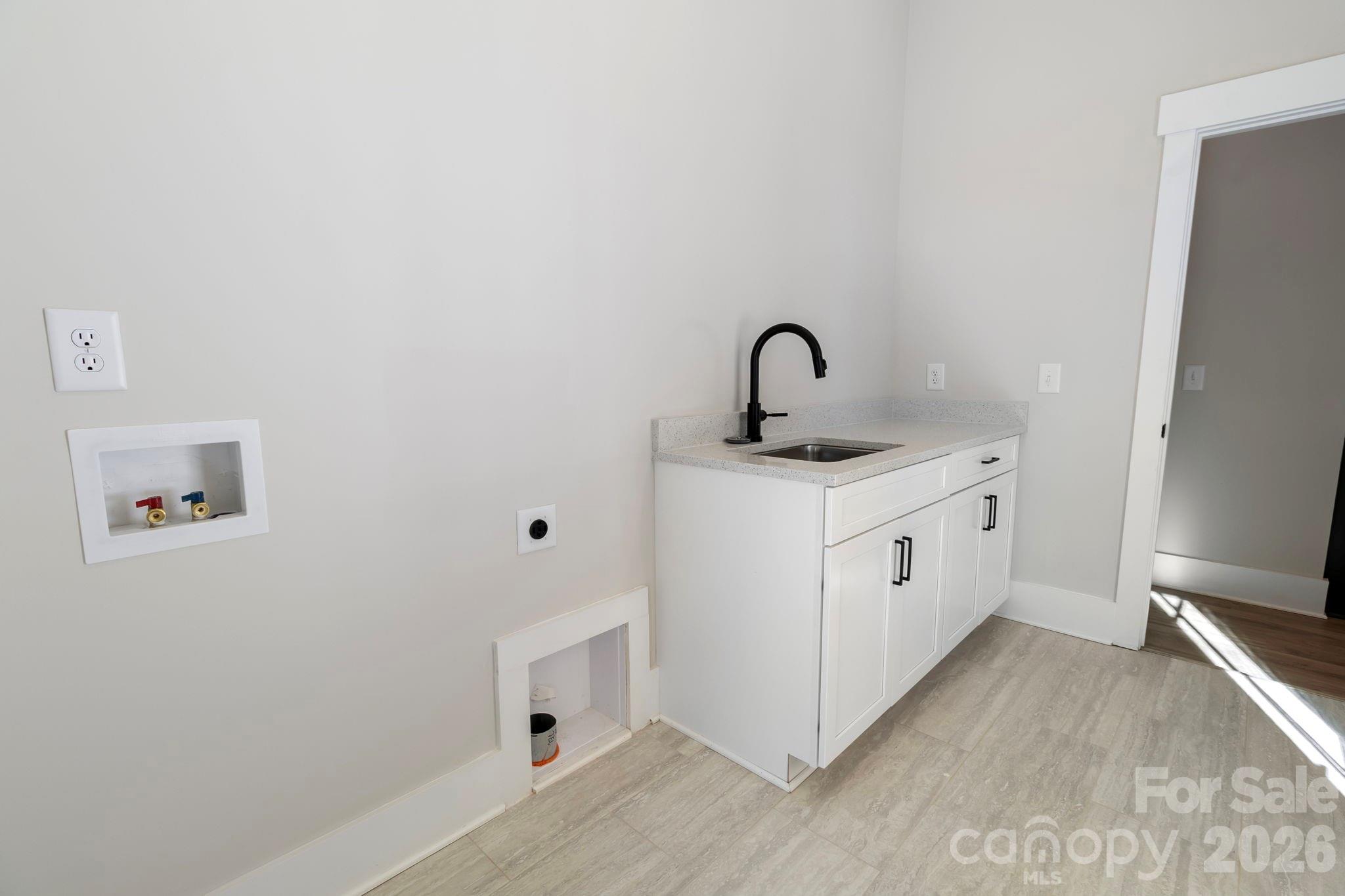 1359 Glasscock Road, Unit 1 Rock Hill, SC 29730 - Photo 23 of 40 a kitchen with white cabinets a sink and dishwasher