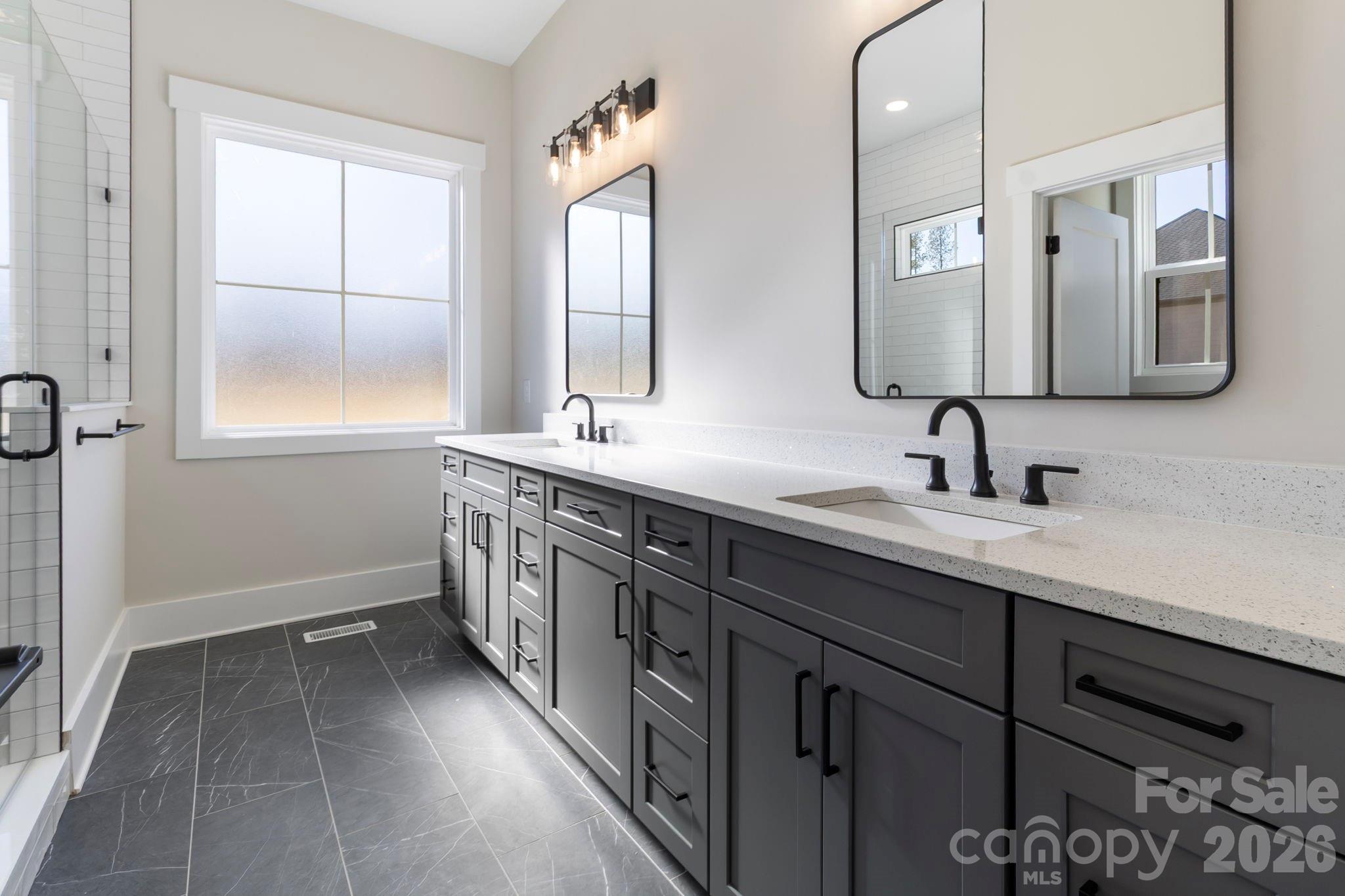 1359 Glasscock Road, Unit 1 Rock Hill, SC 29730 - Photo 5 of 40 a bathroom with a double vanity sink a mirror and a bathtub