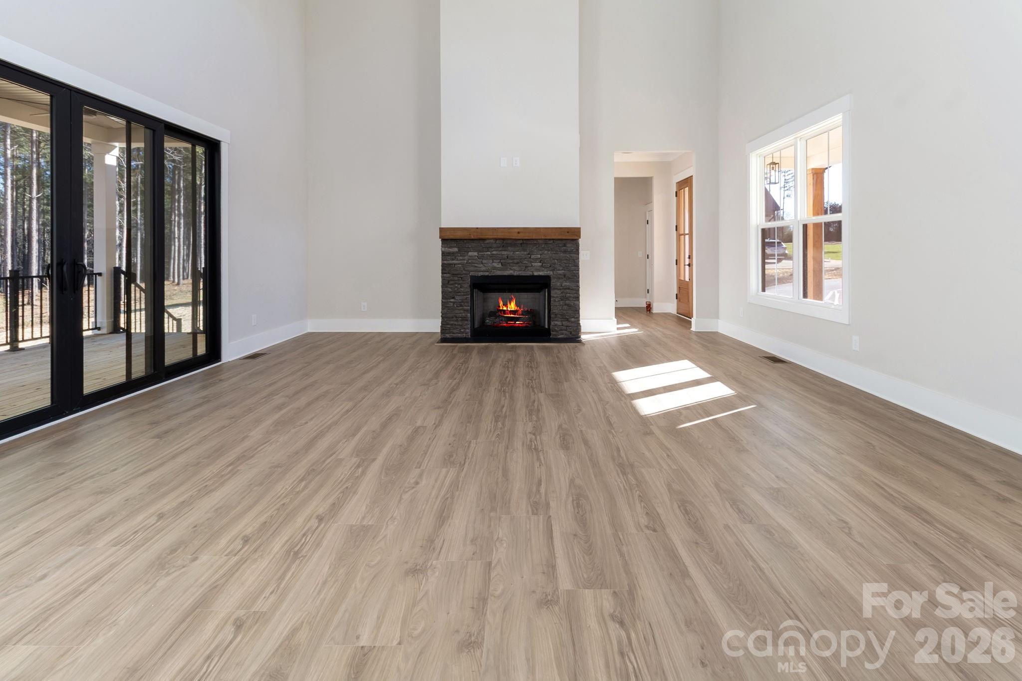 1359 Glasscock Road, Unit 1 Rock Hill, SC 29730 - Photo 6 of 40 a view of an empty room with wooden floor fireplace and a window