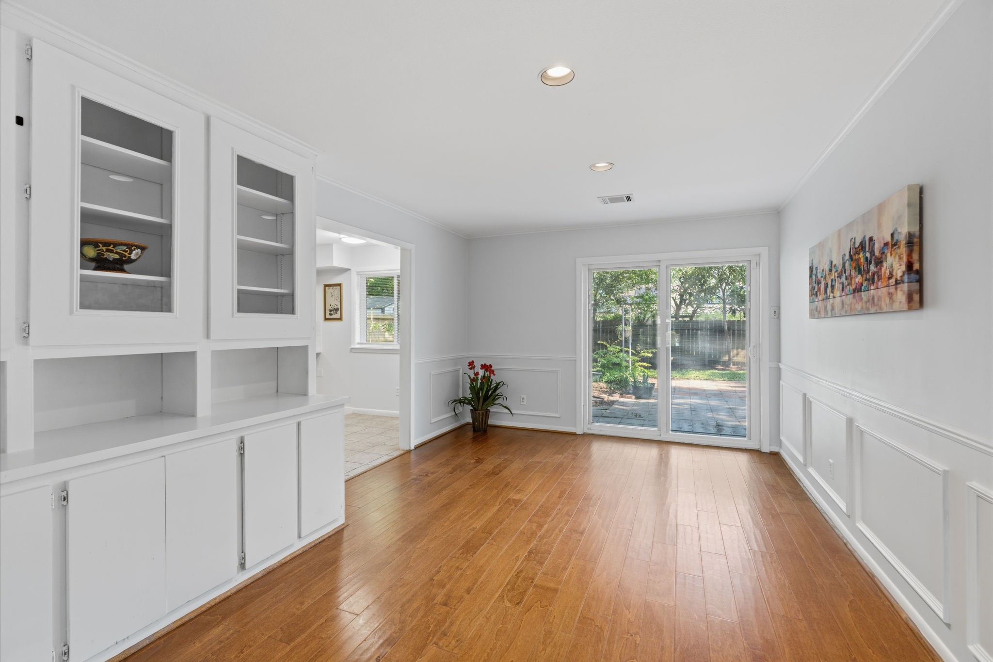 5410 Indigo Street Houston, TX 77096 - Photo 9 of 30 Huge dining area with gleaming floors, built ins and glass doors to the backyard.
