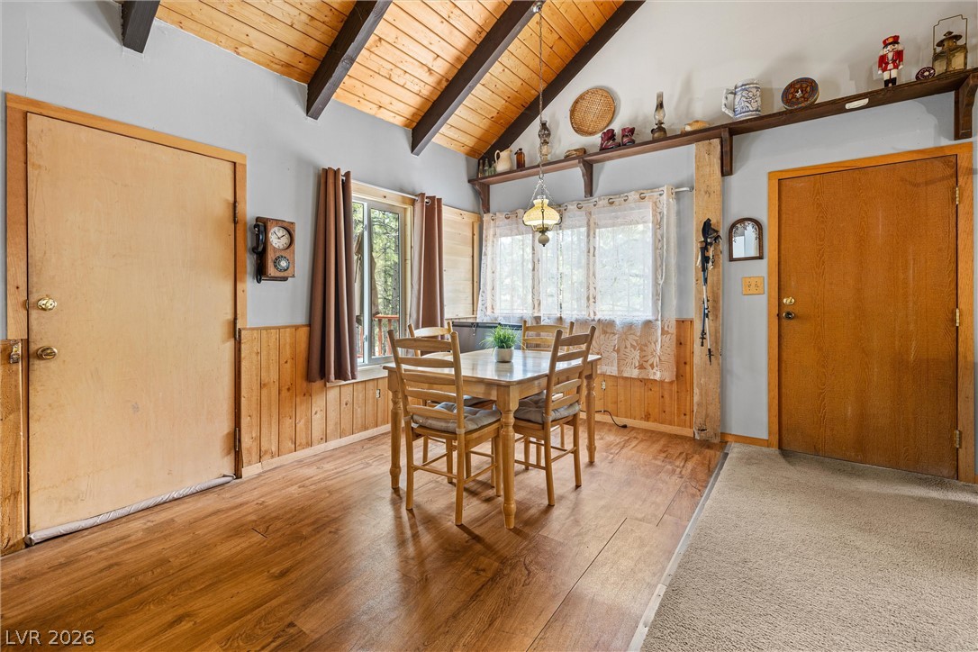 2146 Via Spes Nostra Street Mount Charleston, NV 89124 - Photo 17 of 33 Natural light illuminates this dining area with exposed wood beams and paneling.