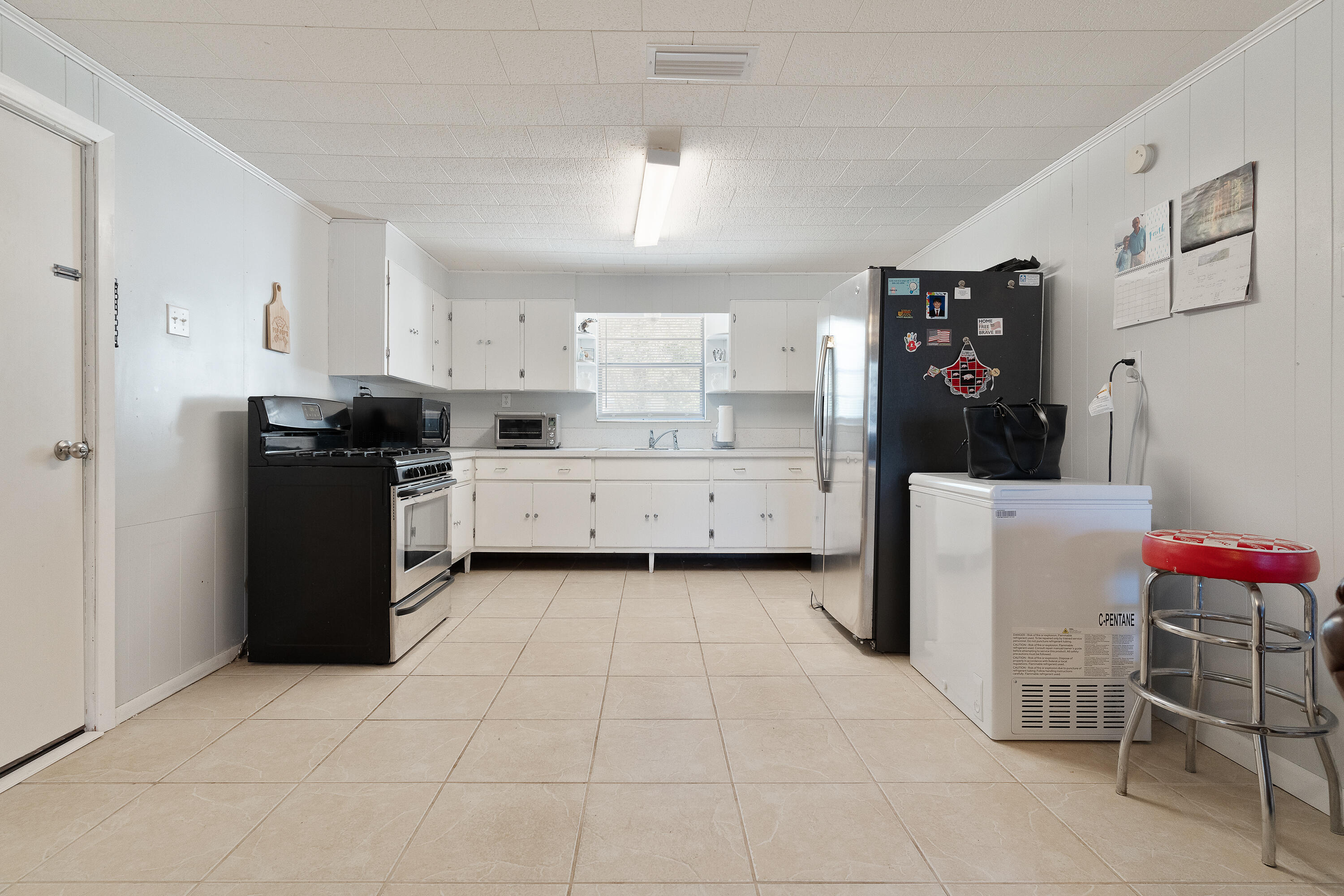 5686 Griffith Cemetery Road Baker, FL 32531 - Photo 13 of 52 a kitchen with granite countertop a refrigerator and a stove top oven