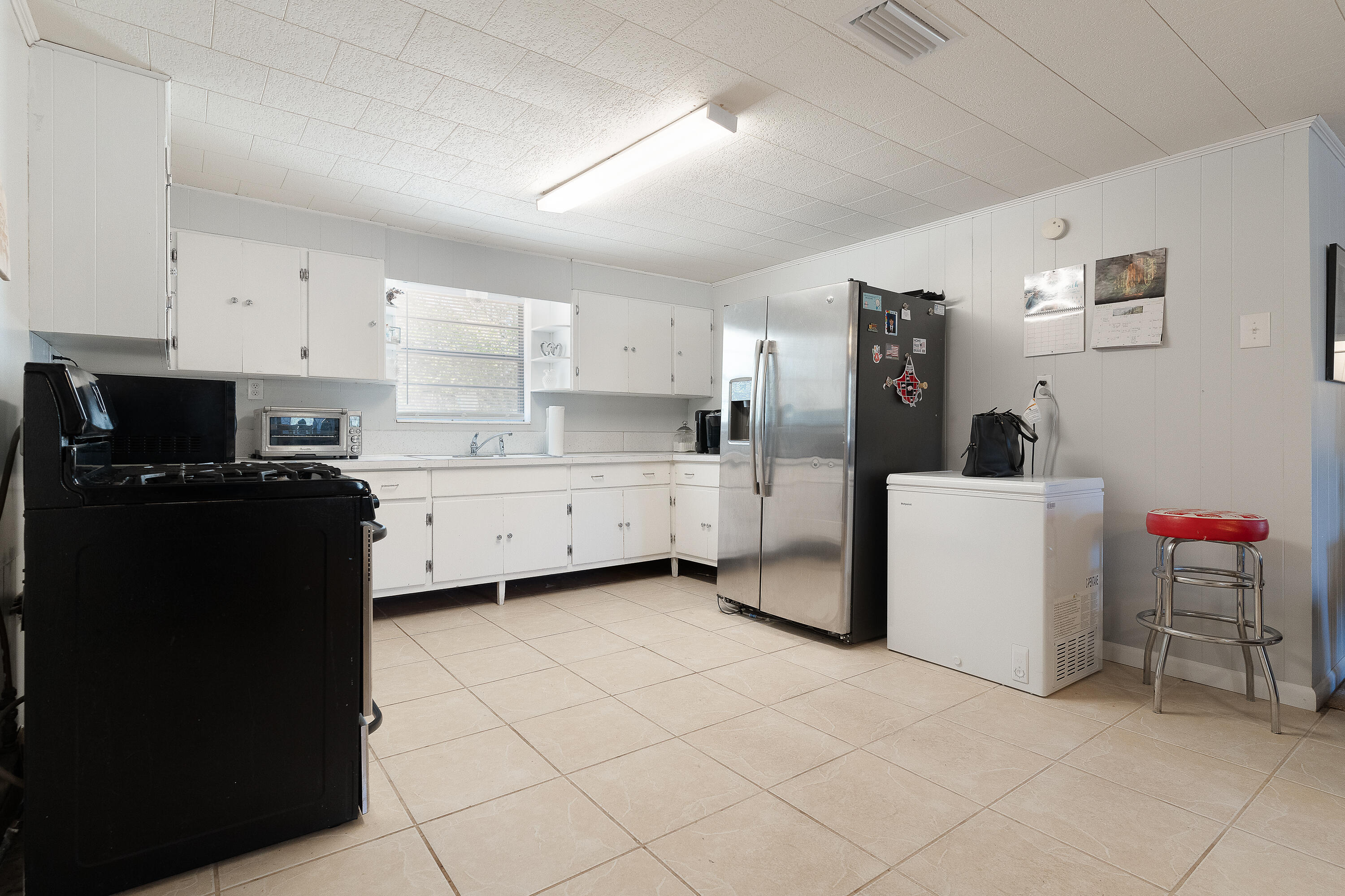 5686 Griffith Cemetery Road Baker, FL 32531 - Photo 14 of 52 a kitchen with a sink a stove and cabinets