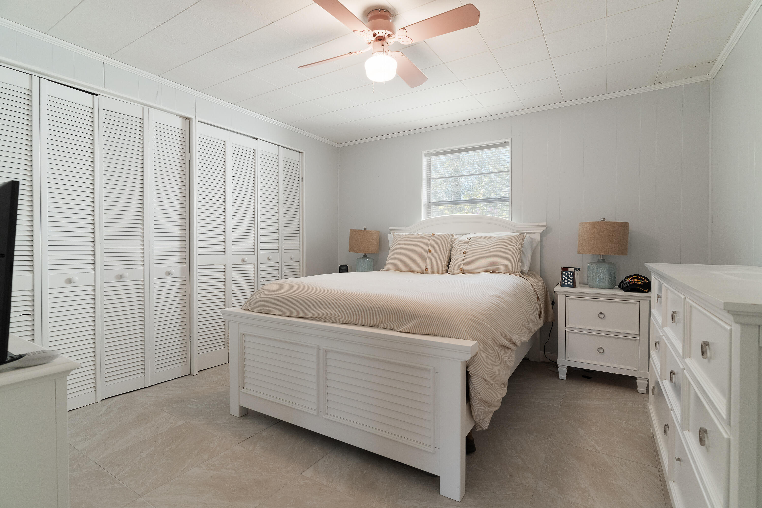 5686 Griffith Cemetery Road Baker, FL 32531 - Photo 18 of 52 a room with a bed and a ceiling fan