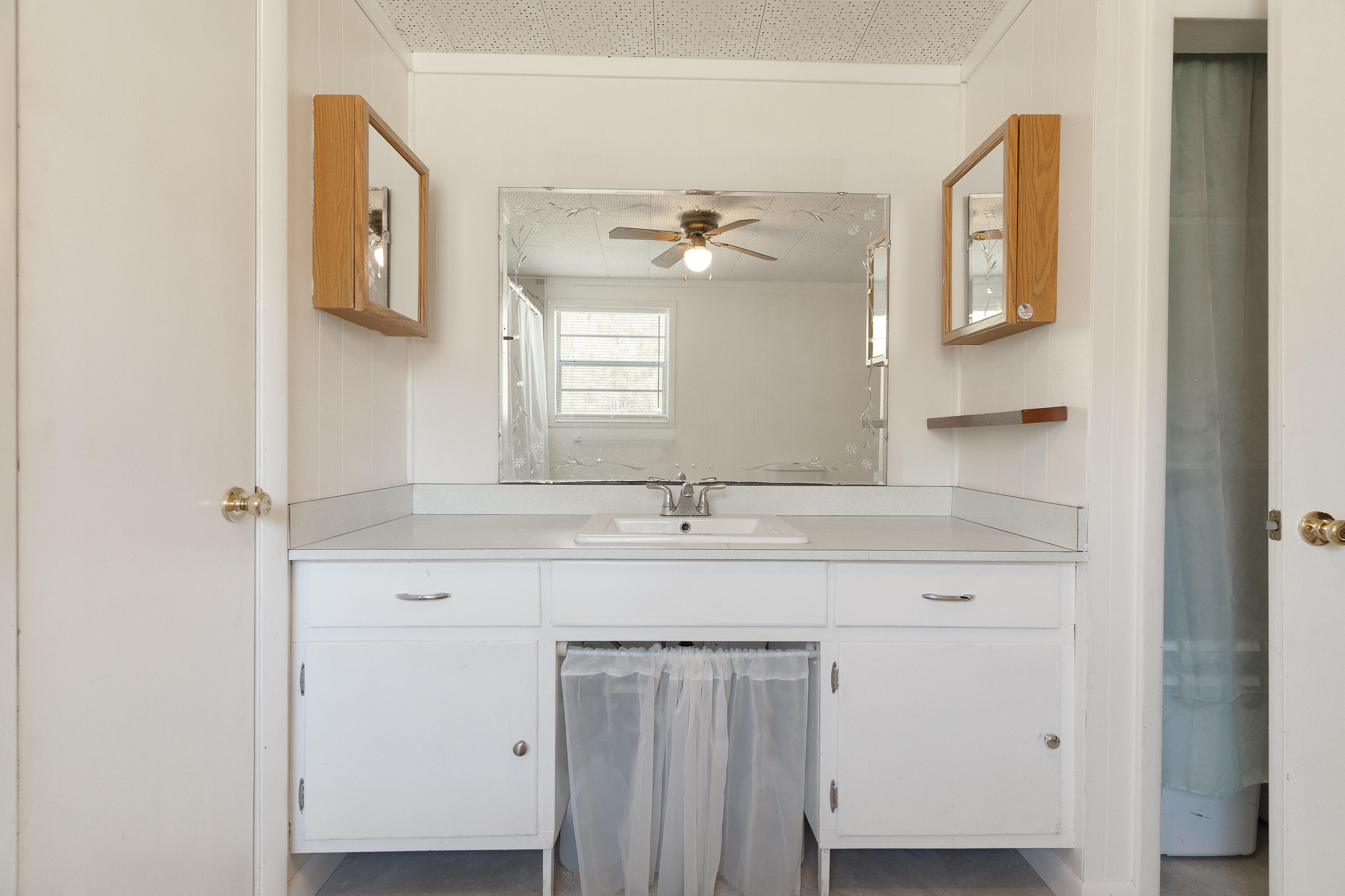 5686 Griffith Cemetery Road Baker, FL 32531 - Photo 22 of 52 a bathroom with a granite countertop sink two mirror and window