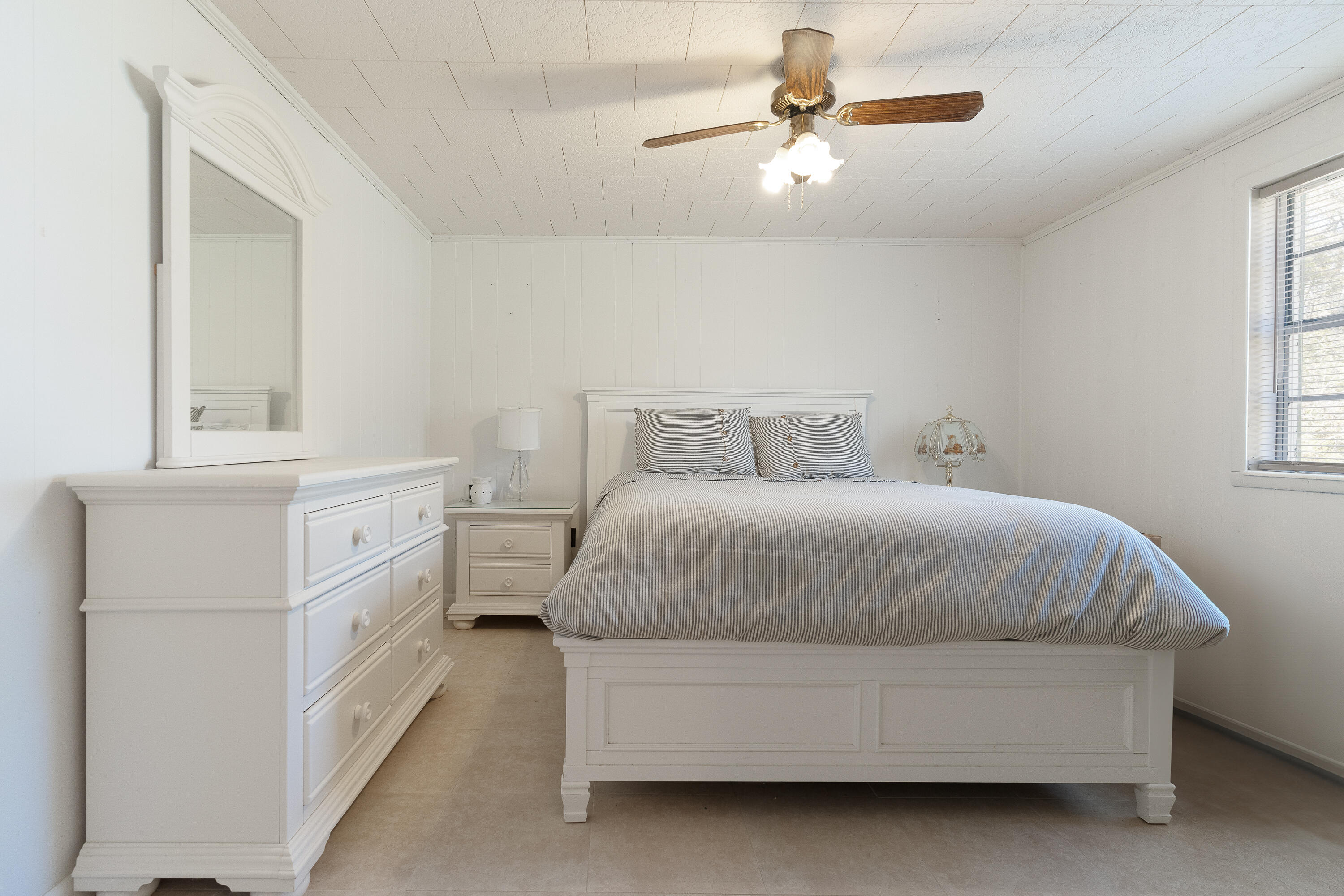 5686 Griffith Cemetery Road Baker, FL 32531 - Photo 24 of 52 a spacious bedroom with a bed and a chandelier