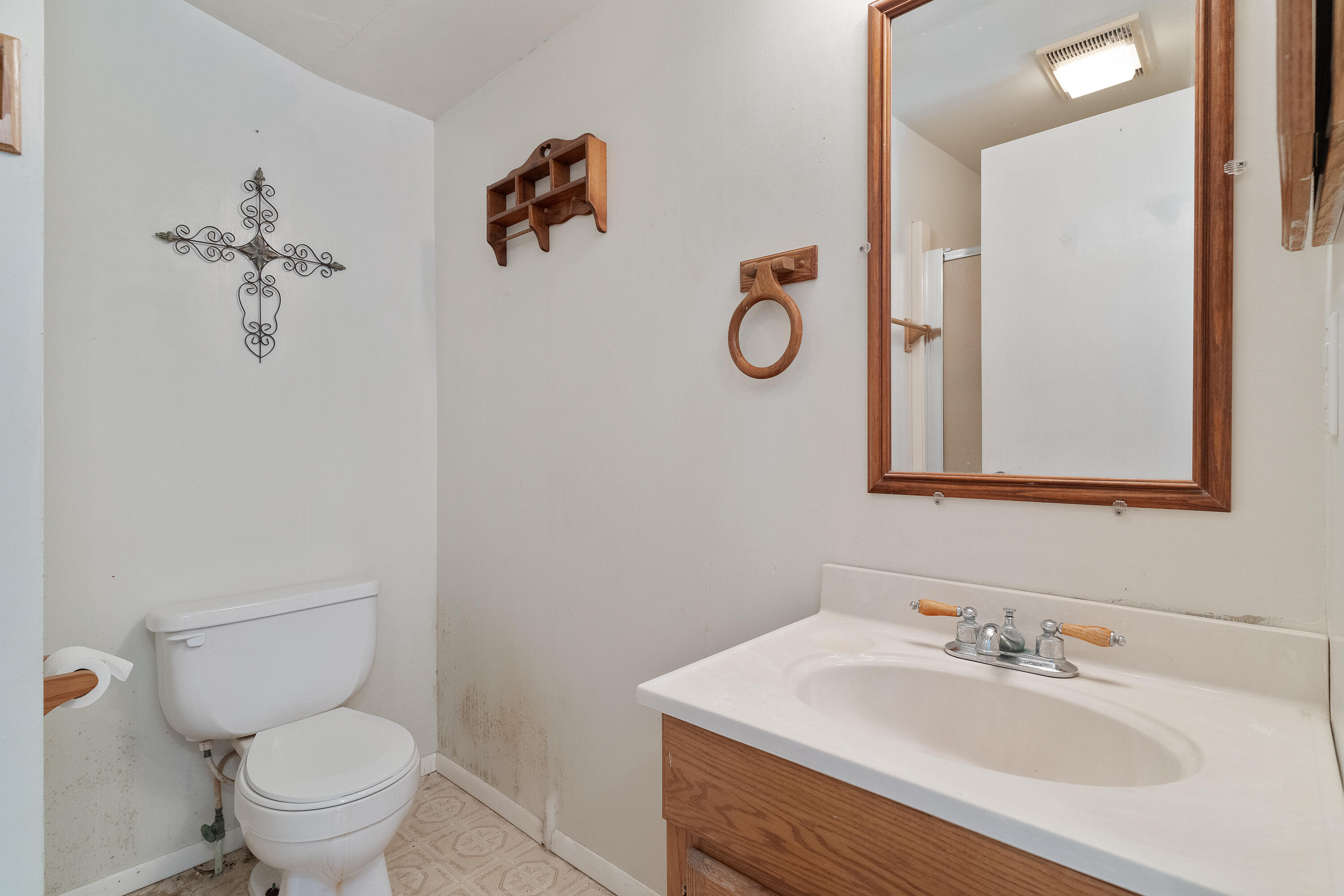 5686 Griffith Cemetery Road Baker, FL 32531 - Photo 26 of 52 a bathroom with a sink mirror and toilet