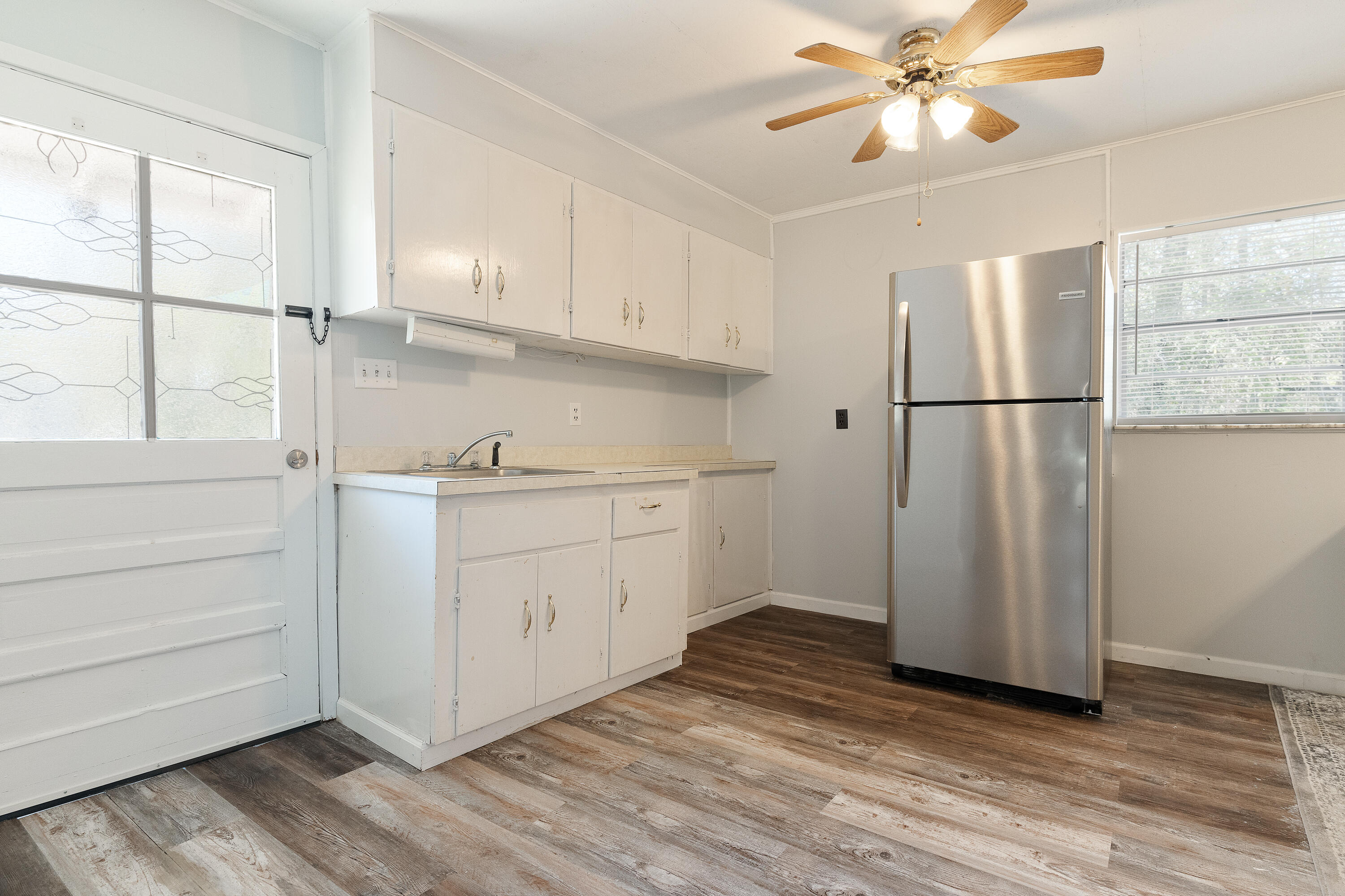 5686 Griffith Cemetery Road Baker, FL 32531 - Photo 30 of 52 a view of a kitchen with wooden floor and electronic appliances