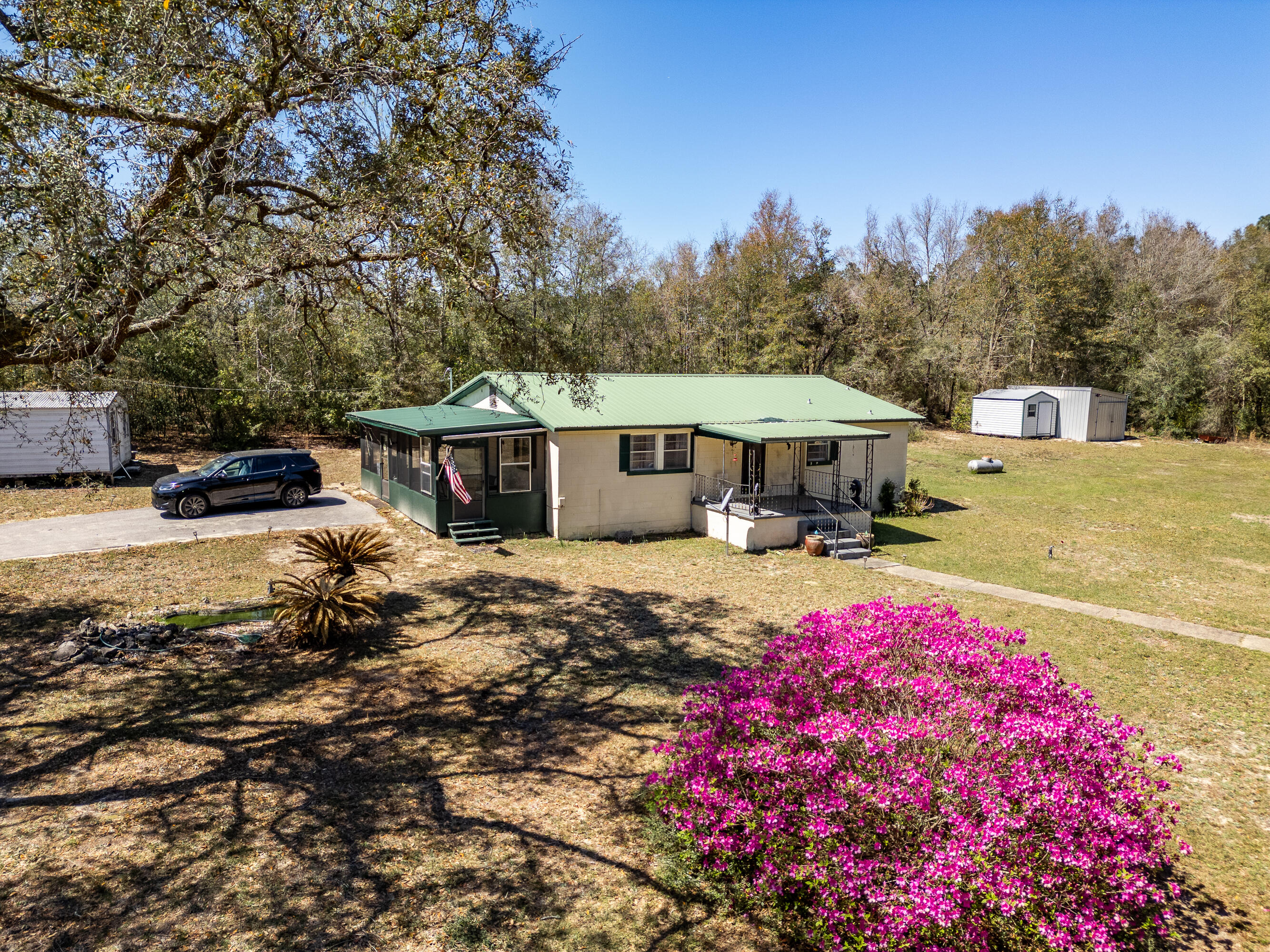 5686 Griffith Cemetery Road Baker, FL 32531 - Photo 4 of 52 a front view of a house with yard and seating area