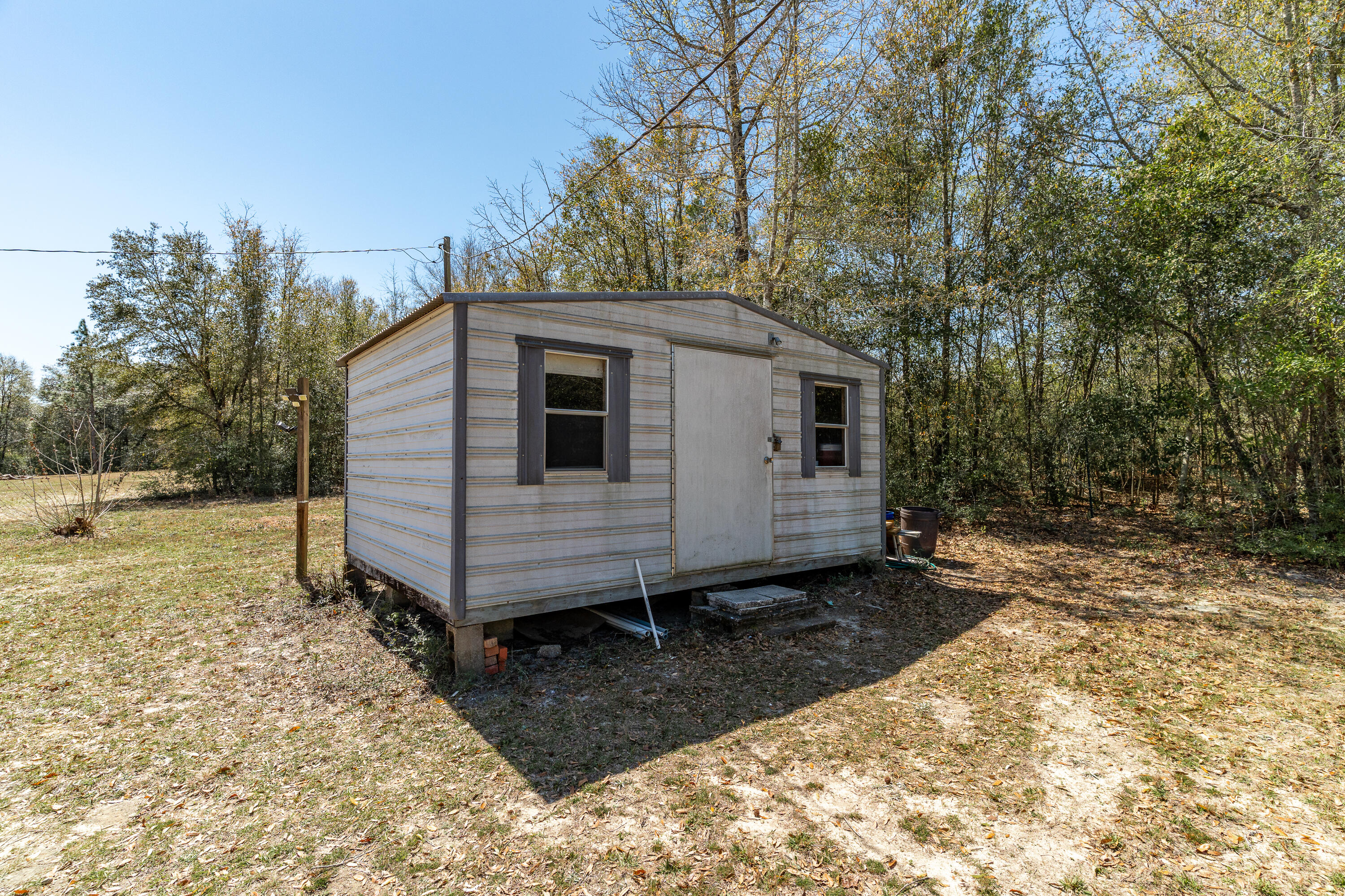 5686 Griffith Cemetery Road Baker, FL 32531 - Photo 46 of 52 a view of a small house with a yard