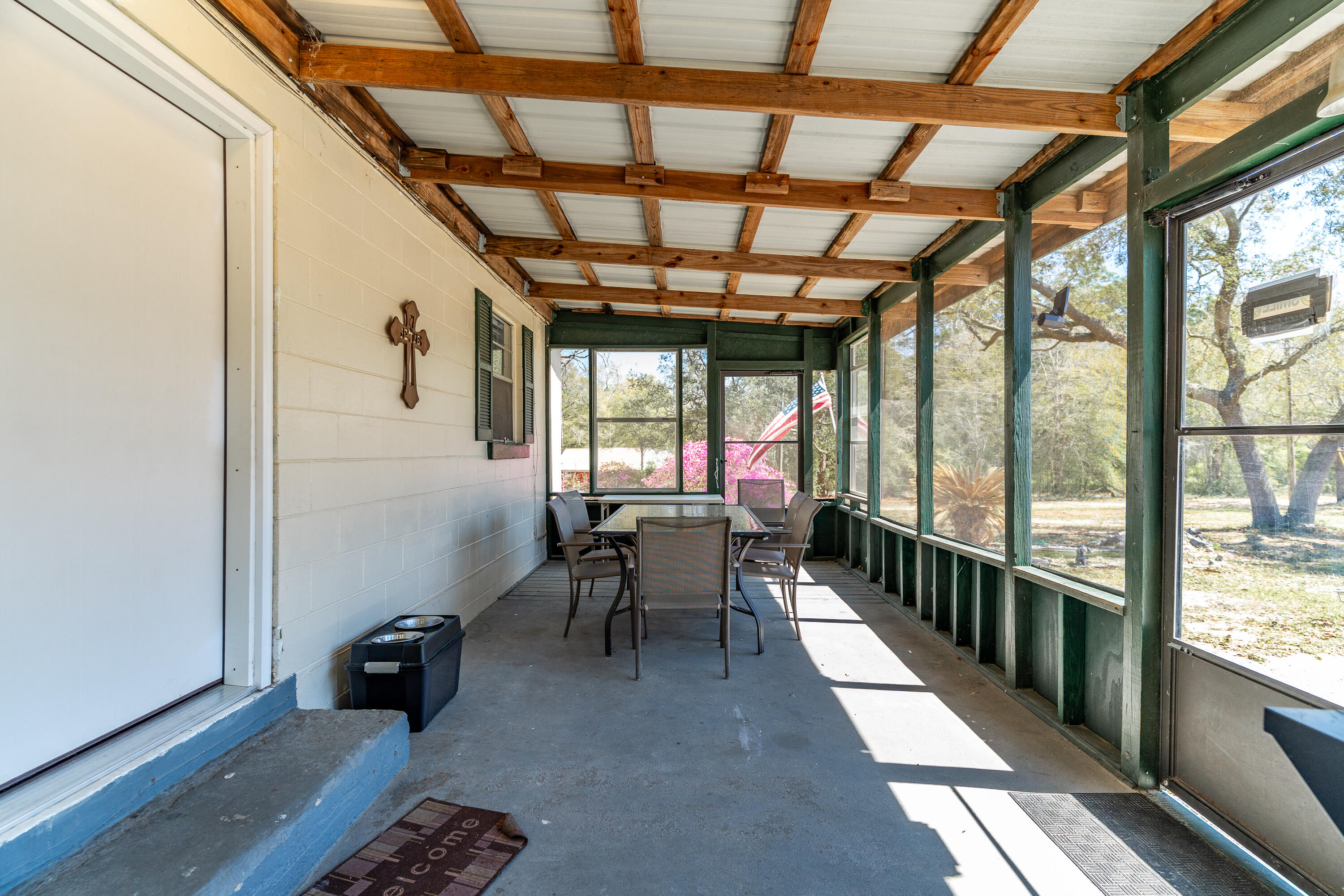 5686 Griffith Cemetery Road Baker, FL 32531 - Photo 5 of 52 a dining room with furniture and a floor to ceiling window