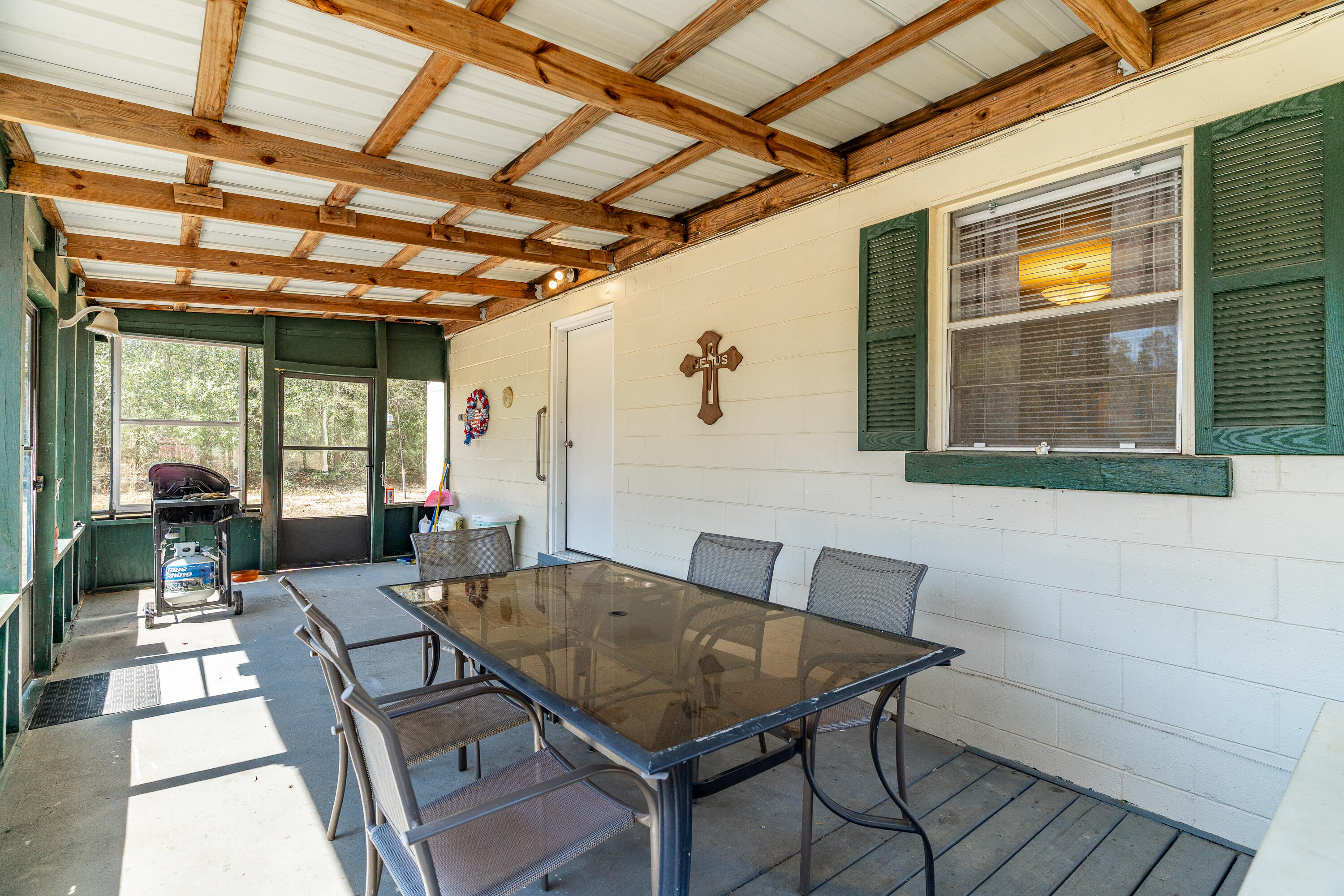 5686 Griffith Cemetery Road Baker, FL 32531 - Photo 6 of 52 a view of a dining room with furniture wooden floor and a potted plant