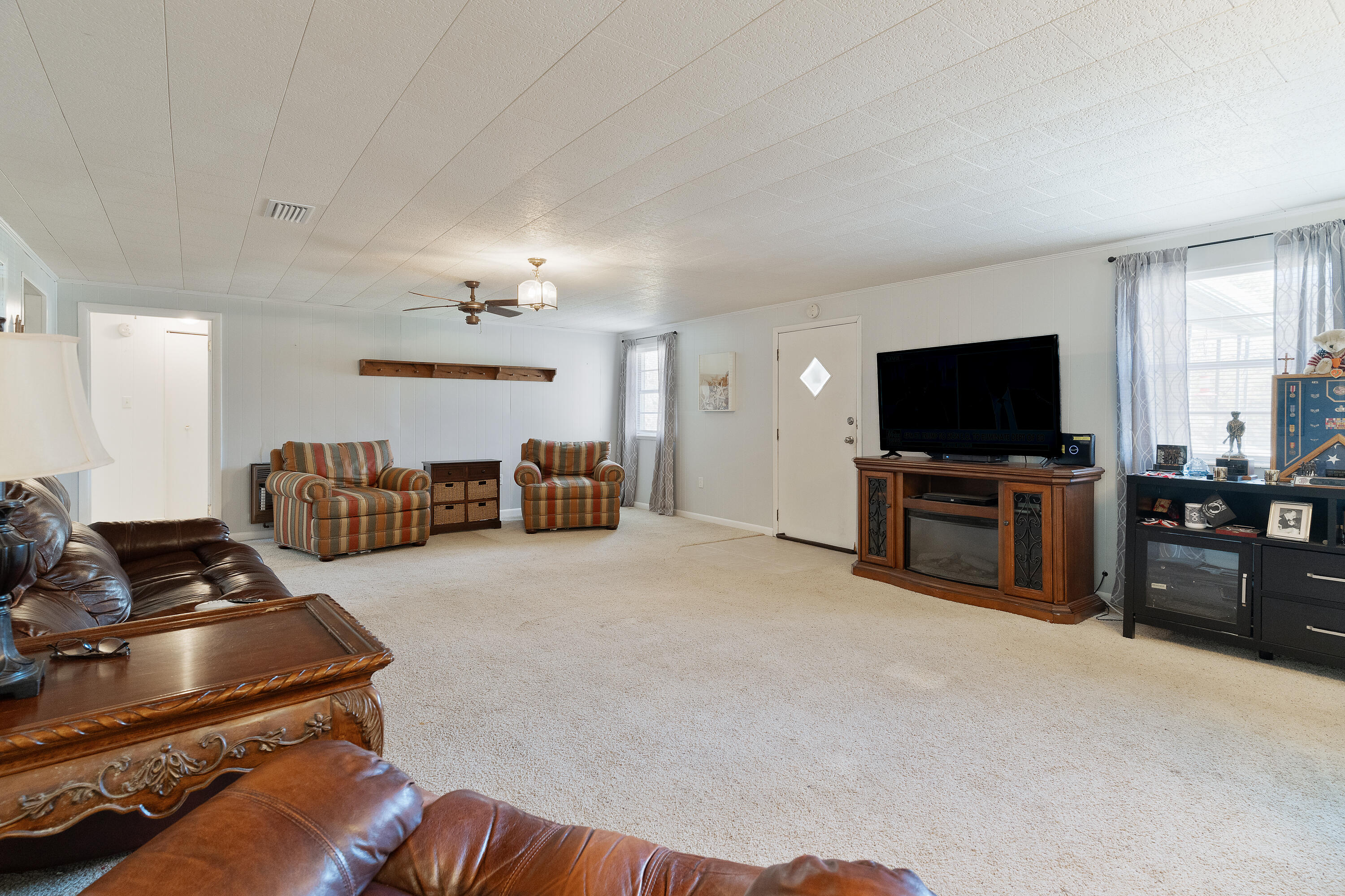 5686 Griffith Cemetery Road Baker, FL 32531 - Photo 7 of 52 a living room with furniture and a flat screen tv