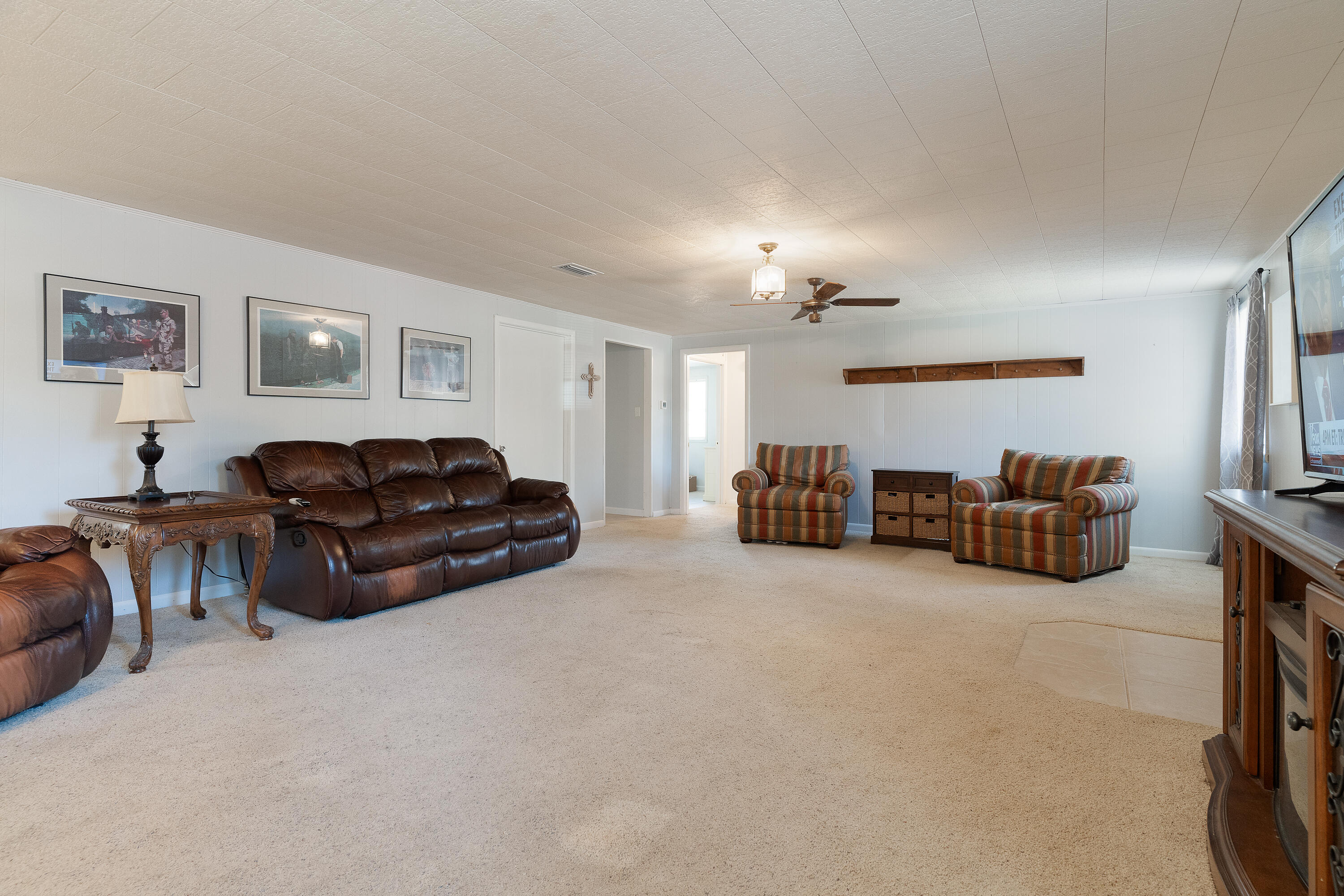 5686 Griffith Cemetery Road Baker, FL 32531 - Photo 8 of 52 a living room with furniture a chandelier and couch