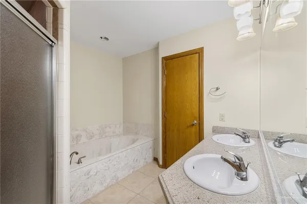 a bathroom with a sink a mirror and a bathtub