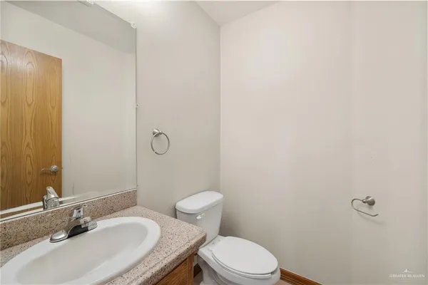 a bathroom with a sink toilet and vanity