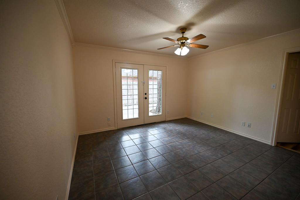 3201 South Garland Street Decatur, TX 76234 - Photo 7 of 20 an empty room with windows and fan