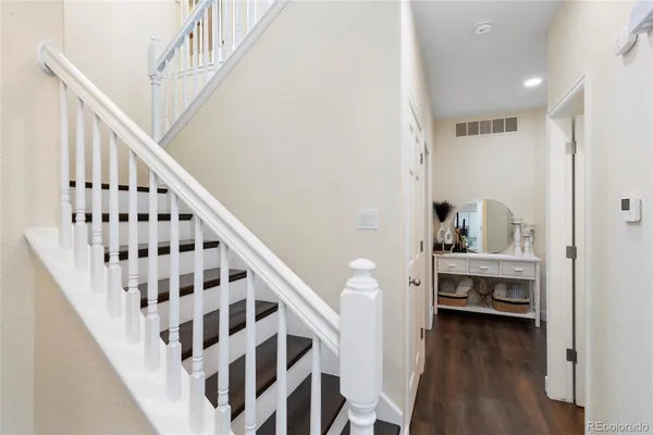 a view of entryway and hall with wooden floor
