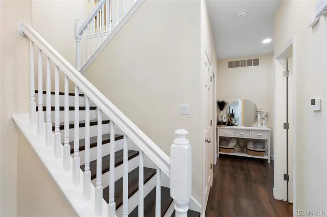 a view of entryway and hall with wooden floor