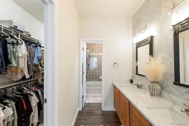 a bathroom with a double vanity sink and a mirror
