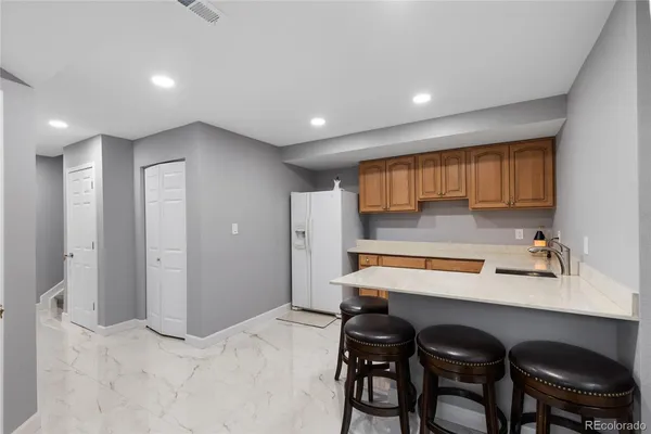 a kitchen with a table chairs sink and cabinets