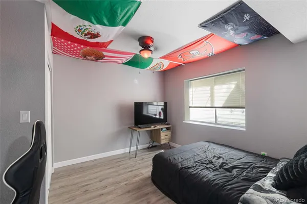 a bedroom with a bed and wooden floor