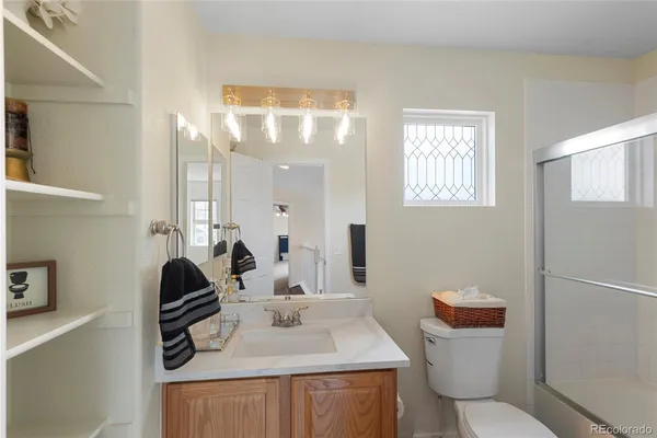 a bathroom with a sink toilet and mirror