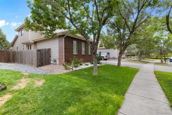 a front view of house with yard and green space