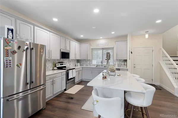 a kitchen with stainless steel appliances a refrigerator stove microwave and cabinets