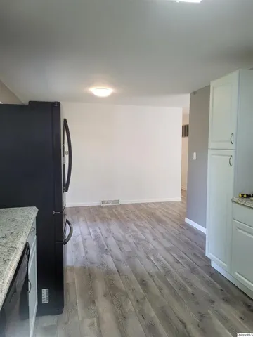 a white toilet sitting next to a bathroom sink and vanity