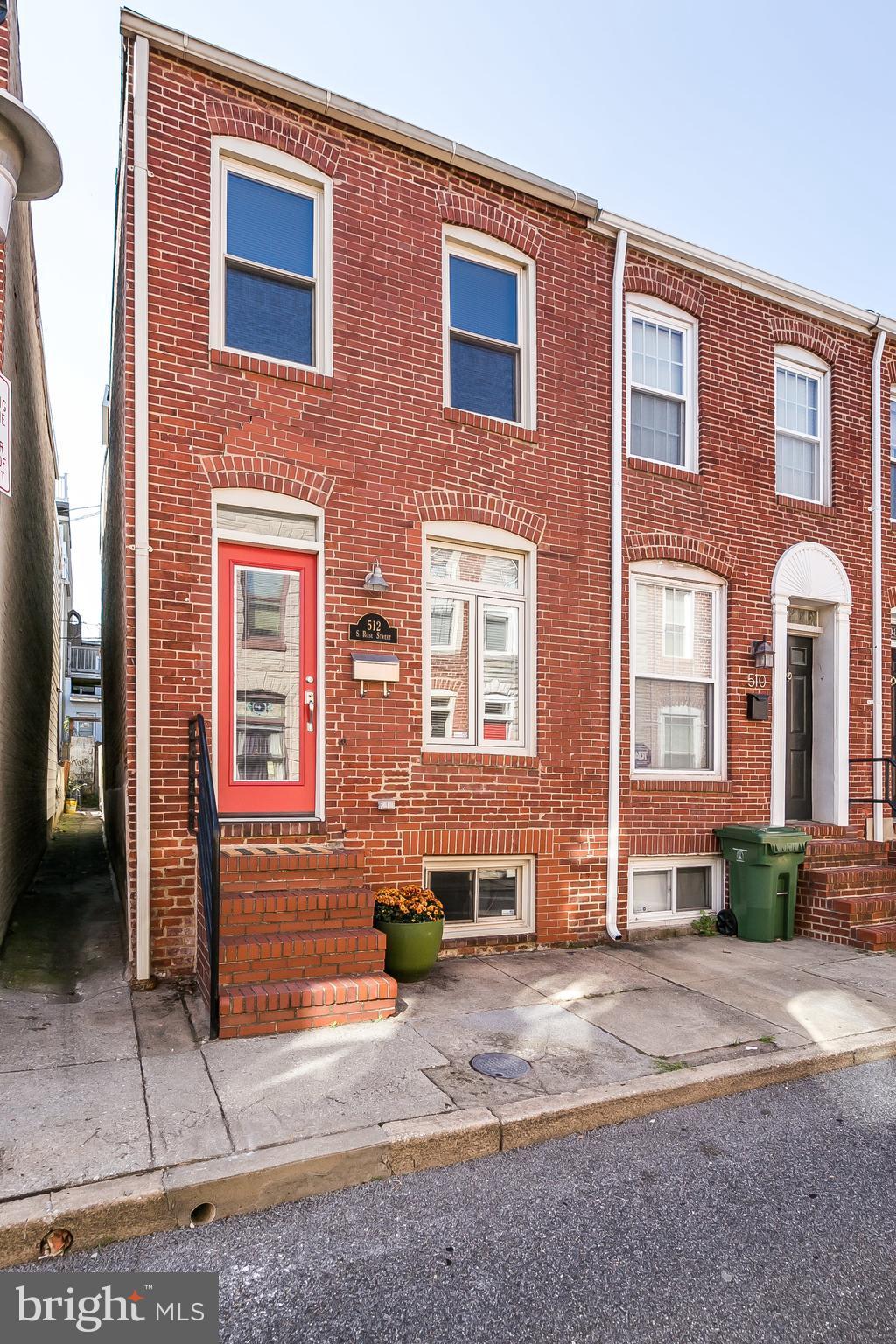 512 South Rose Street Baltimore, MD 21224 - Photo 1 of 30 a front view of a house with a yard and a garage