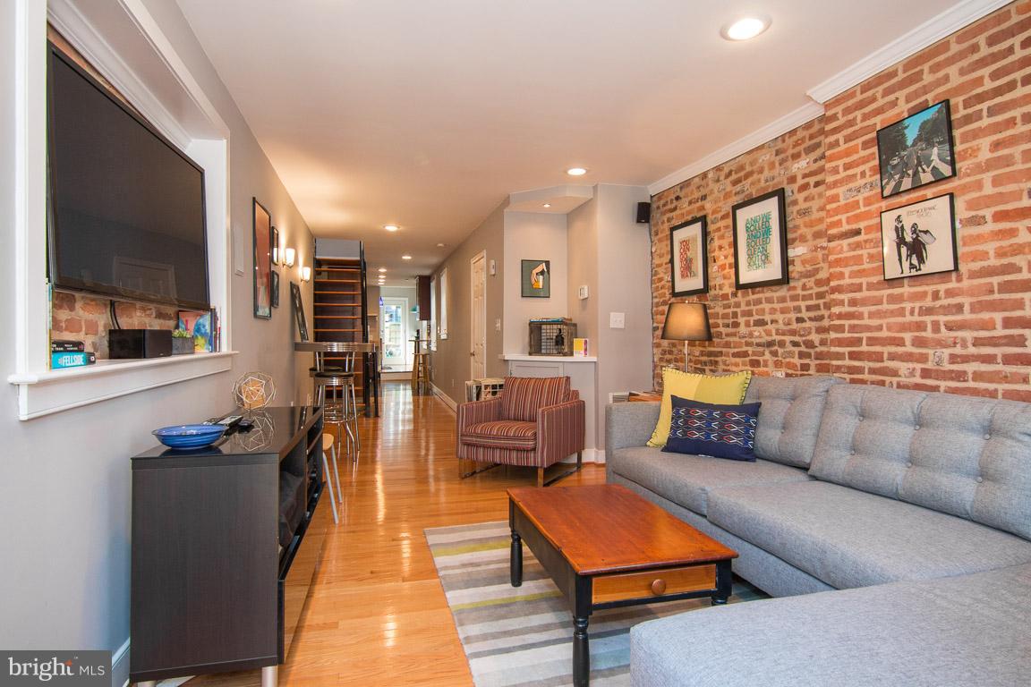 512 South Rose Street Baltimore, MD 21224 - Photo 2 of 30 a living room with furniture and a flat screen tv