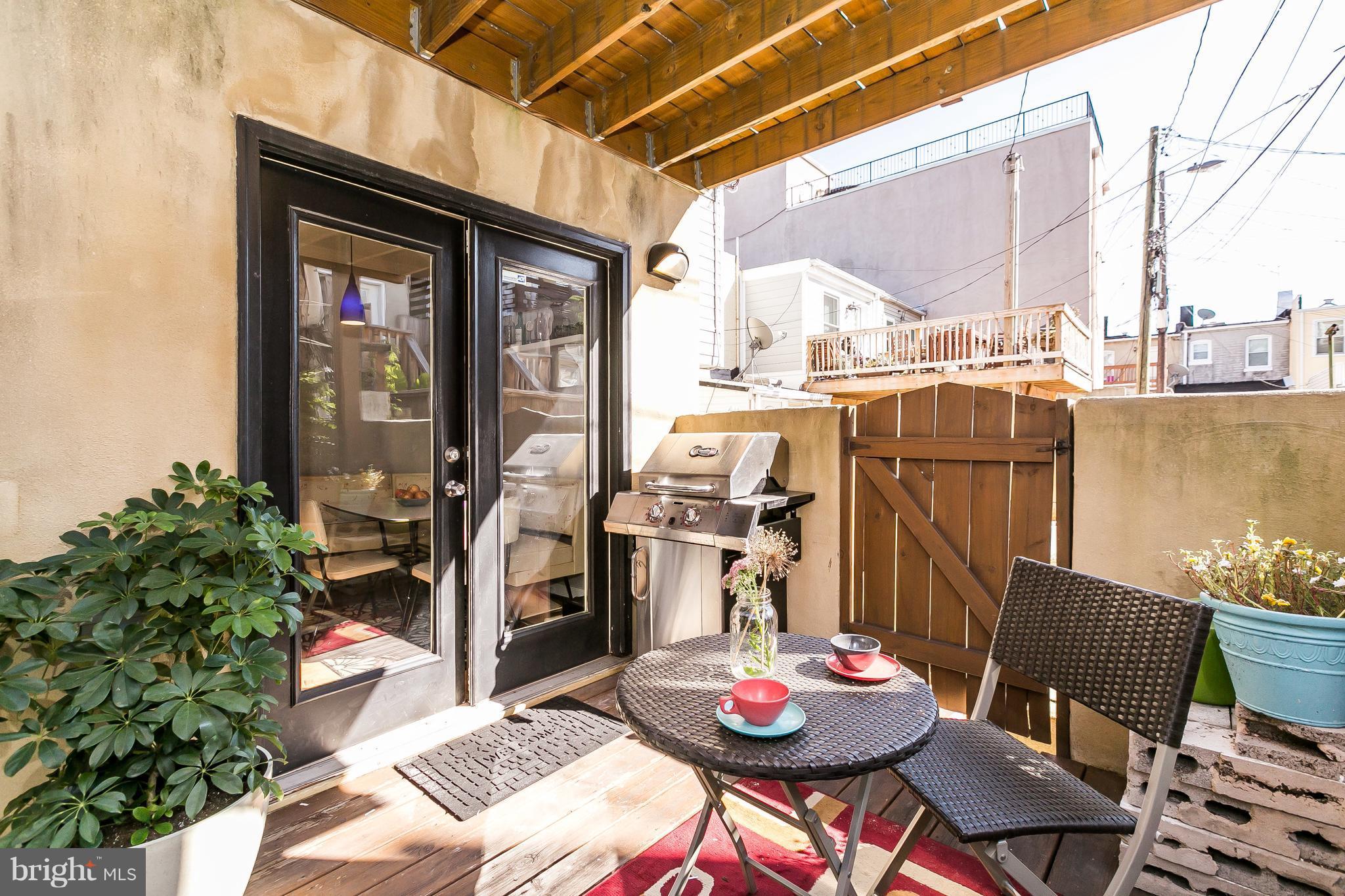 512 South Rose Street Baltimore, MD 21224 - Photo 13 of 30 a outdoor dining space with furniture and a potted plant