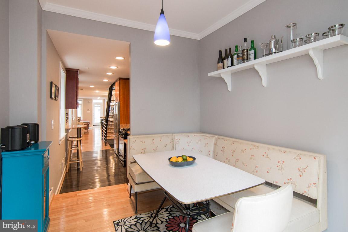 512 South Rose Street Baltimore, MD 21224 - Photo 14 of 30 a view of kitchen island with furniture and wooden floor