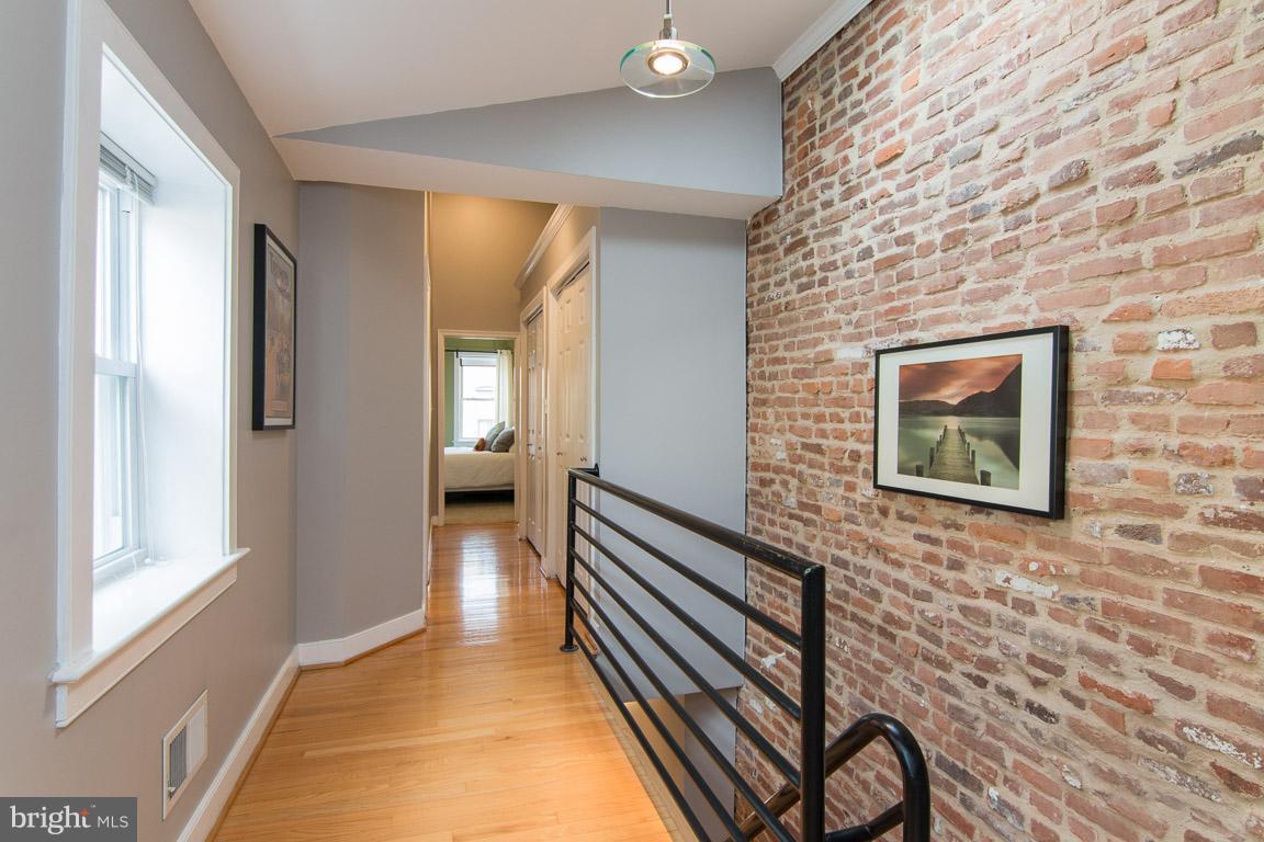512 South Rose Street Baltimore, MD 21224 - Photo 17 of 30 a hallway with front door wooden floor and windows
