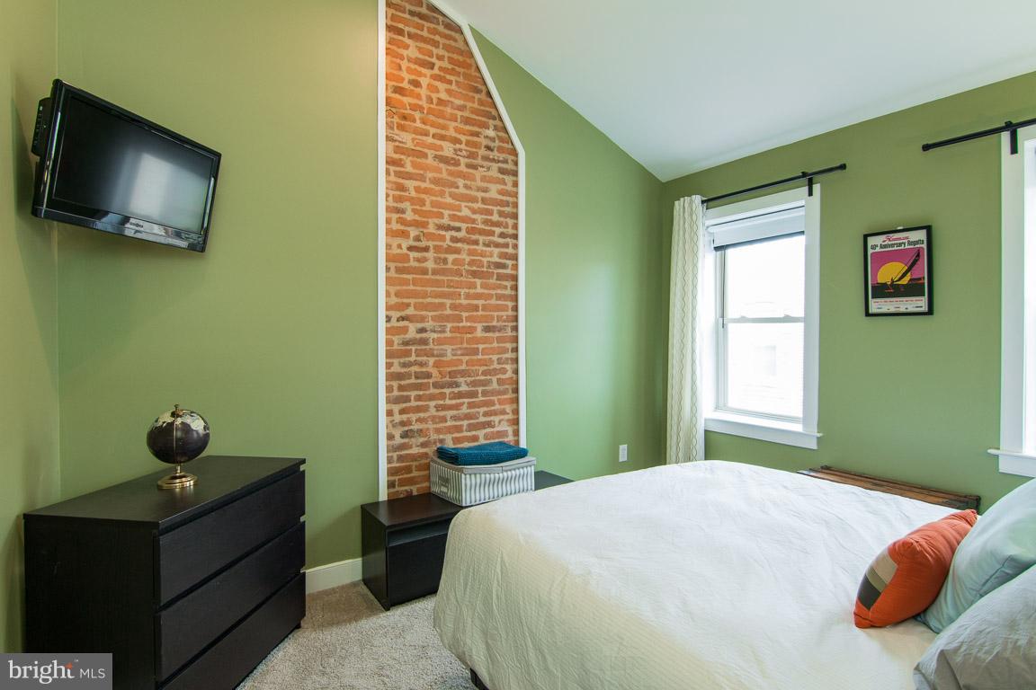512 South Rose Street Baltimore, MD 21224 - Photo 20 of 30 a bedroom with a bed and a flat screen tv