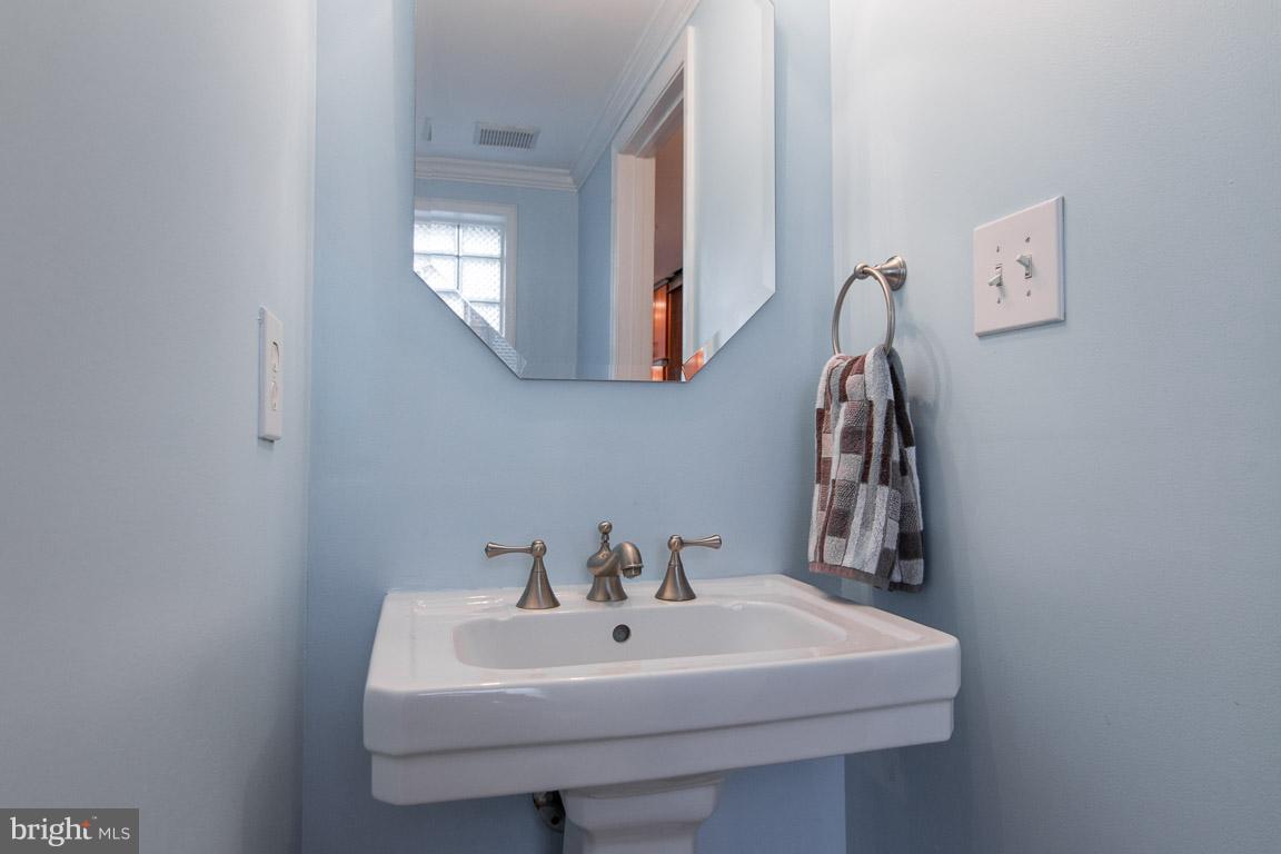 512 South Rose Street Baltimore, MD 21224 - Photo 7 of 30 a bathroom with a sink a mirror and vanity