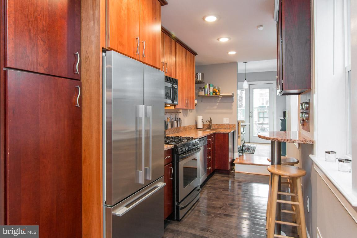 512 South Rose Street Baltimore, MD 21224 - Photo 8 of 30 a kitchen with stainless steel appliances granite countertop a refrigerator a stove and a sink