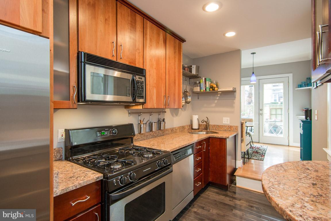 512 South Rose Street Baltimore, MD 21224 - Photo 9 of 30 a kitchen with stainless steel appliances granite countertop a stove a sink and a microwave