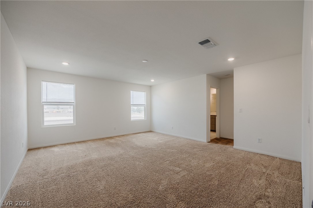 5927 Coja Street Las Vegas, NV 89113 - Photo 15 of 32 Empty room with light colored carpet, baseboards, and recessed lighting
