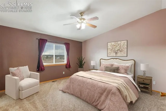 a bedroom with a bed couches and window