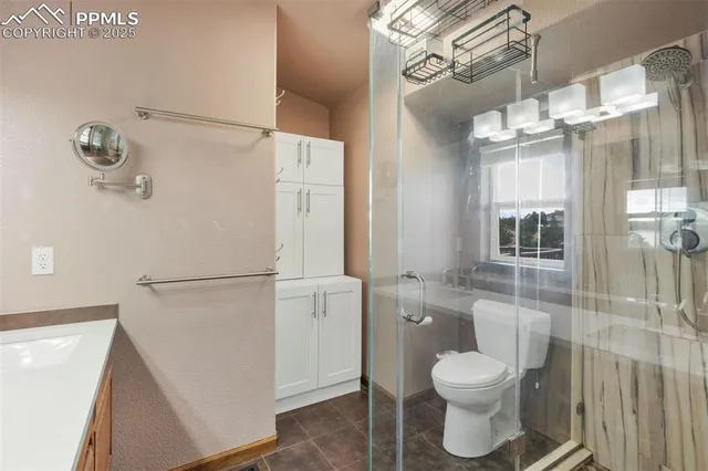 a bathroom with a toilet sink and shower