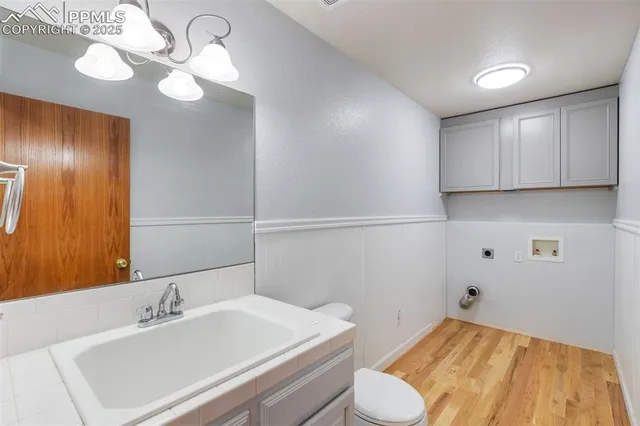 a bathroom with a sink a toilet and mirror