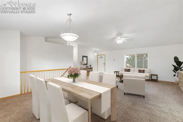 a living room with couches and a dining table with wooden floor
