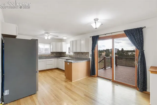 a kitchen with a refrigerator and a sink
