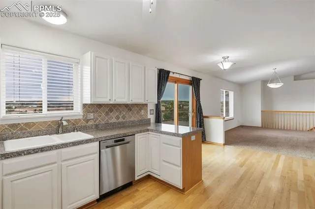 a kitchen with granite countertop a sink and a stove top oven