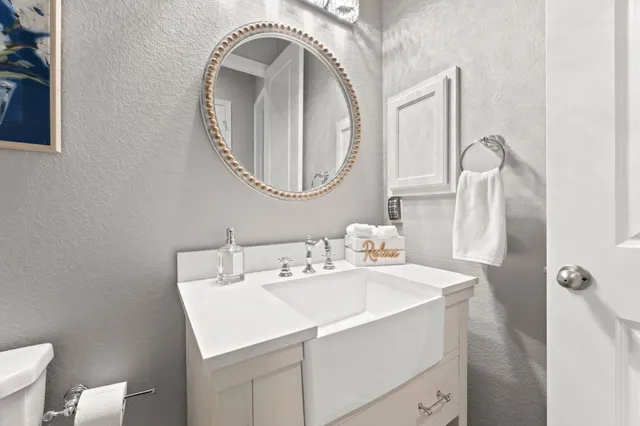 a bathroom with a toilet sink vanity tub and shower