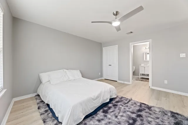 a spacious bedroom with a bed and a couch