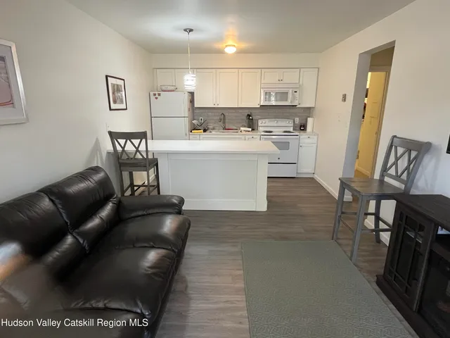 a kitchen with a refrigerator coffee maker on the counter
