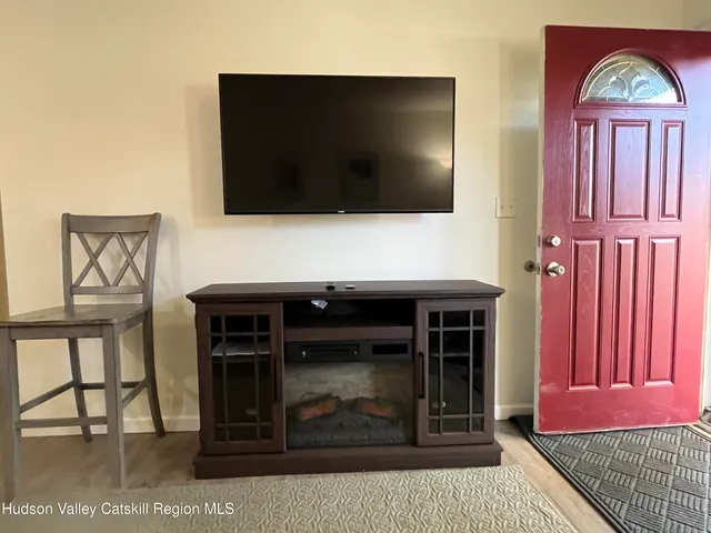 a living room with a flat screen tv and outdoor view